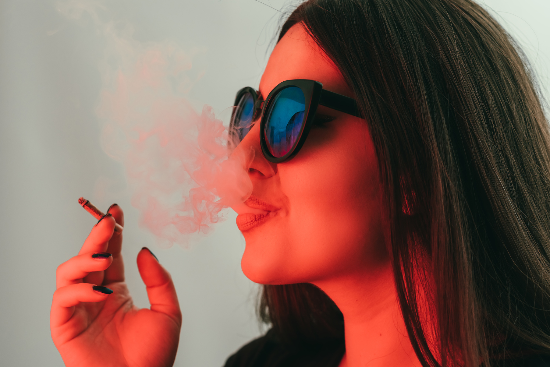 Young woman smoking weed, multicolored portrait