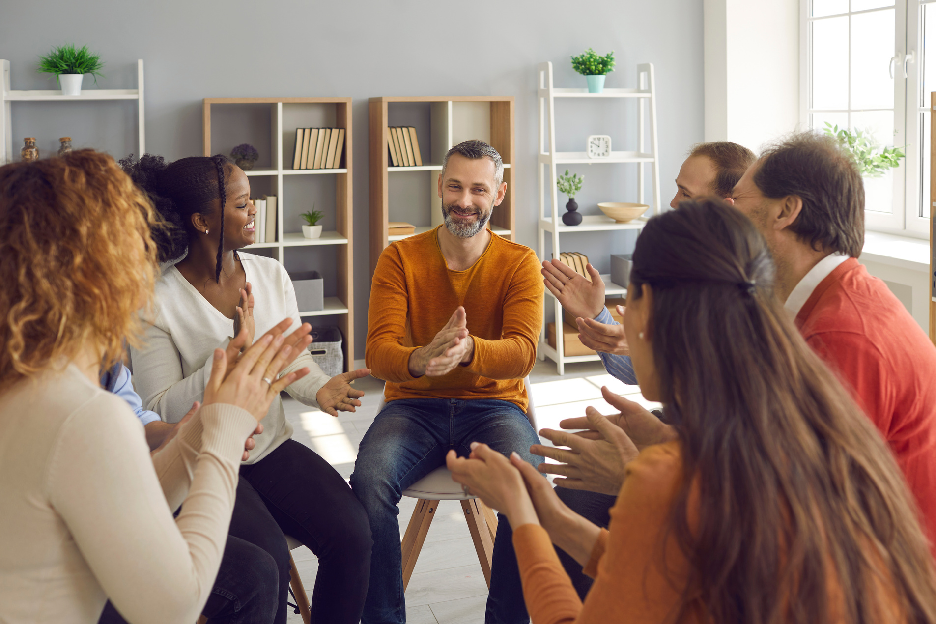 Happy Patients Applauding Mature Psychologist or Therapist after Group Therapy Session